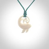 A hand carved bone whale pendant. This is a lovely piece carved to bring pleasure to the lucky wearer. It is a friendly pendant which we will ship to you free wherever you live. Carved by NZ Pacific and for sale online. Provided with an adjustable blue cord.